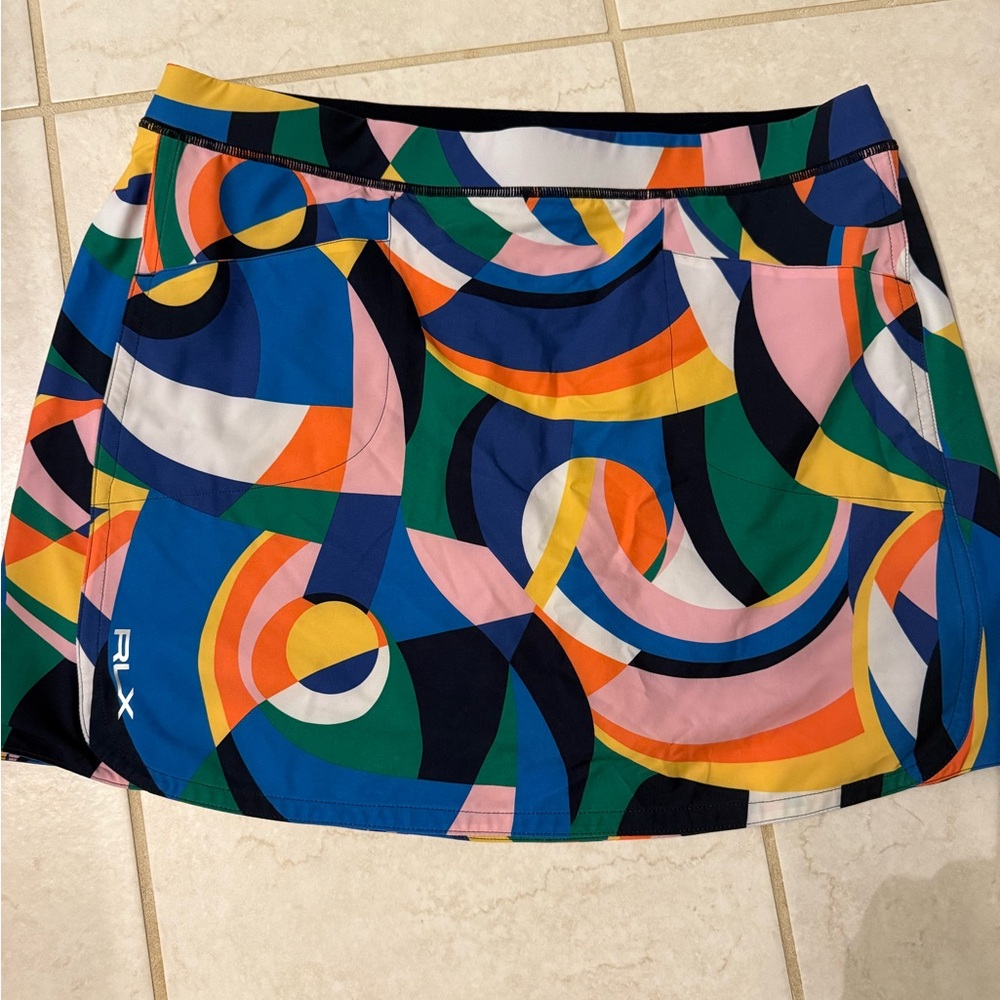 RLX Golf skort. NWT. Size large. Multi colored geometric pattern